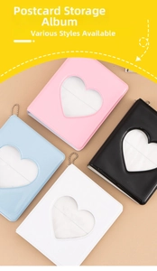 Macro detail of heart-shaped cutout photo albums in pink, blue, black, and white colors