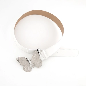 Detailed view of white leather belt with ornate silver metal butterfly buckle on white background