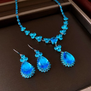 Detail shot of vintage silver blue teardrop pendant necklace and matching earring set