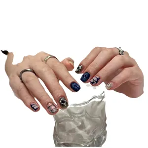 Handmade press-on nails with dark blue starry texture, silver metal accents and rhinestones