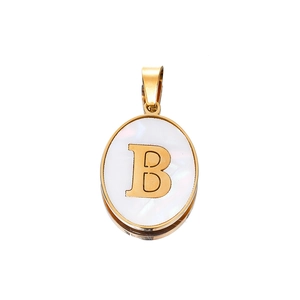 Close-up of golden stainless steel oval pendant with white mother of pearl and letter B