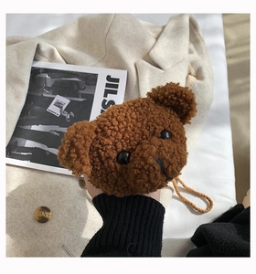 Detailed view of a brown plush teddy bear crossbody bag made of soft sherpa material