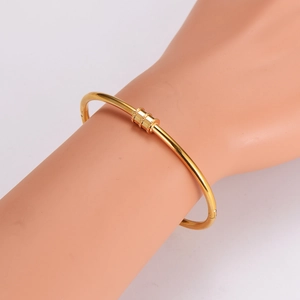 Elegant minimalist gold stainless steel hinged bangle with a sliding textured charm