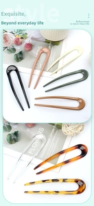 Close-up of minimalist U-shaped hair pins in various colors and acetate textures