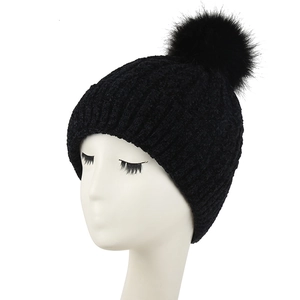Women's thick black knit beanie with fluffy faux fur pom pom for winter warmth