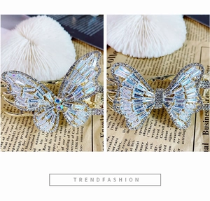 Detailed view of silver butterfly hair clips with sparkling zircon and crystal inlay