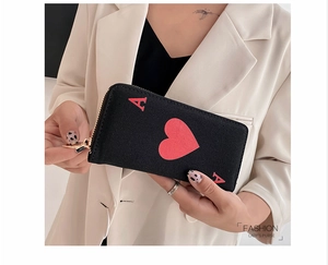 Detail showing high-capacity canvas purse with Ace of Hearts design and gold zipper