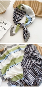 Detail of 70cm square silk scarf featuring geometric pink and grey stripe patterns