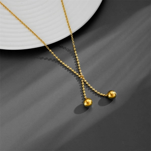 Elegant gold titanium steel Y-shaped necklace featuring dual polished golden beads