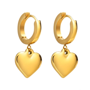 Polished golden stainless steel heart shaped hoop earrings for women on white background