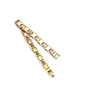 Golden stainless steel magnetic bracelet with pyramid crystals and black magnets