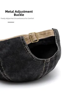 Detail of adjustable bronze metal buckle and khaki strap on vintage gray washed cap