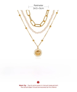 Detailed view of layered gold necklace with sun pendant, pearls and size specifications