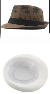 Detail view of woven paper straw fedora with palm tree print and inner lining structure