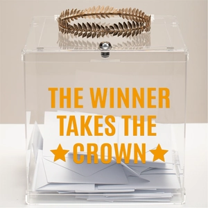 Detail of clear acrylic ballot box with gold crown and The Winner Takes The Crown text