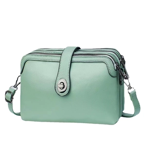 Three-layer mint green crossbody bag with pebbled leather and metal swivel clasp