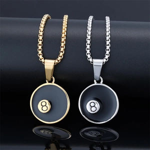Detail view of gold and silver billiards number 8 pendants on black leather stands