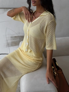 Detailed knit texture of light yellow crochet cardigan and hollow out maxi skirt set
