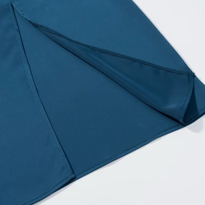 Detail view of the side slit and high-quality stitching on a dark blue satin dress