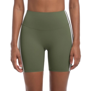 Detail of high-waisted army green yoga shorts with white side stripes and slim fit