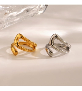 Close-up of gold and silver irregular geometric open rings with polished finish