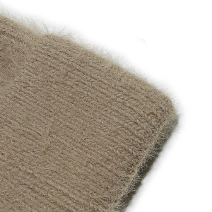 Macro shot of camel knit beanie featuring fluffy faux mink fur and thick thermal texture