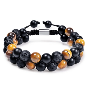 Detailed close-up of woven bracelet featuring tiger eye, lava rock and onyx beads