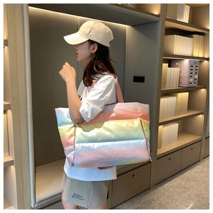 Rainbow gradient quilted fitness bag shown on shoulder in a modern indoor lifestyle setting