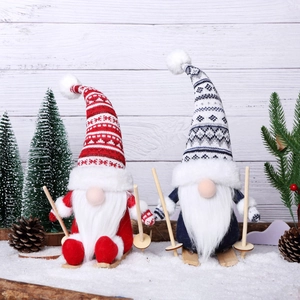 Christmas gnome shelf sitters with wooden skis on snow background for holiday decor