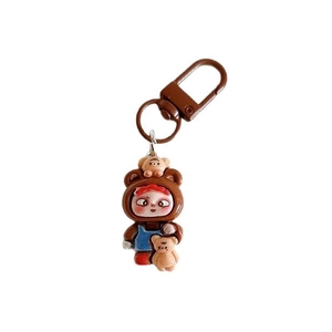 Cartoon boy in brown bear costume keychain with blue overalls and metal ring
