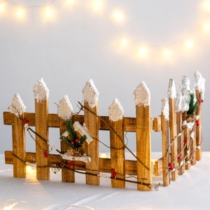 Christmas wooden fence tree base decoration with artificial snow, pine cones and red berries