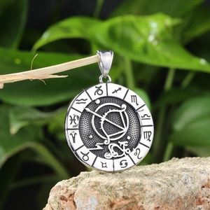 Detailed macro of vintage stainless steel Sagittarius zodiac pendant on a natural branch