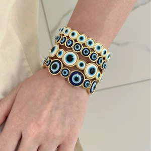 Vintage evil eye bracelet set in gold-finished zinc alloy with multi-layered blue eye charms