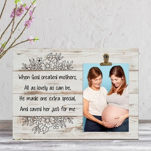 Close-up of rustic wood frame with bronze clip and sentimental Mother's Day poem