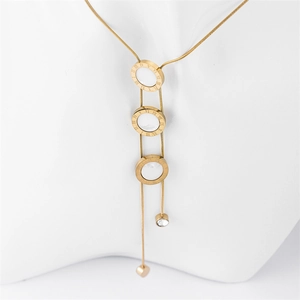 Golden necklace with Roman numeral rings, tassel chains, and zircon heart pendant on mannequin