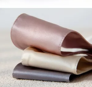 Detailed view of premium silk fabric with fine stitching in muted purple and gold tones