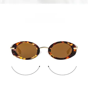 Close-up of retro oval sunglasses with tortoiseshell frames and gold metal accents