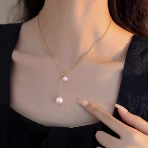 French style titanium steel necklace with two delicate pearls on a gold finish chain