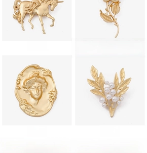 Detailed view of vintage baroque brooches including unicorn, floral and cameo styles