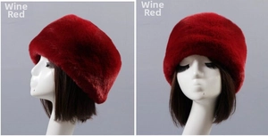 Detail view of wine red faux rabbit fur winter hat with thick plush texture and round top