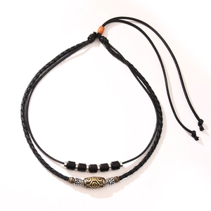 Handcrafted vintage Dzi bead necklace with black braided wax rope and metal accents