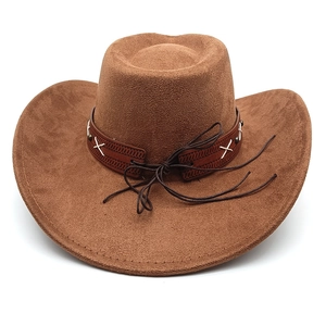 Detail of western cowboy hat with brown leather braided band and metallic studs