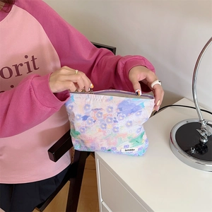Detailed interior view of floral cotton makeup bag showing spacious storage and lining