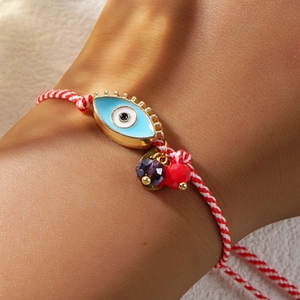 Πλεκτό κόκκινο και λευκό βραχιόλι Evil Eye με μπλε γούρι και μωβ κρυστάλλινη χάντρα