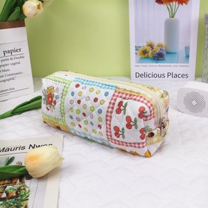 Detail of quilted cotton fabric patterns featuring cherry and floral patchwork design