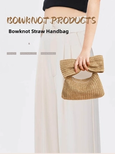 Close-up of a woven straw handbag featuring a large bow detail and natural texture