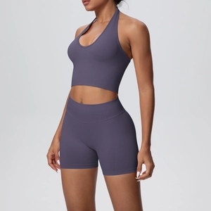 Detailed side view of high-waisted seamless biker shorts and halter neck sports bra set