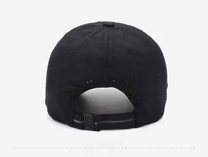 Detail of breathable mesh fabric and adjustable plastic buckle on back of black sports cap