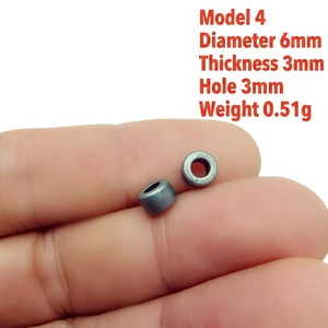 Detailed size view of a 6mm silver metallic spacer bead held to show scale and dimensions