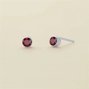 Ruby red round cut stud earrings set in silver finish stainless steel bezel